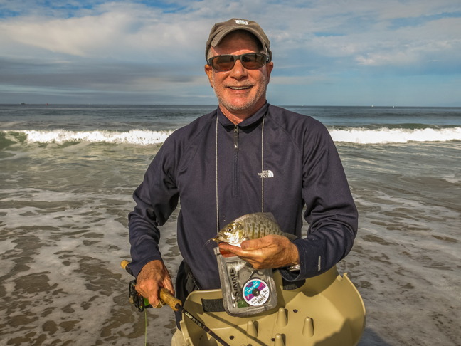 Howard Schecter is all grins after landing a surf perch on a beautiful Sunday morning near LAX. photo by Al Q