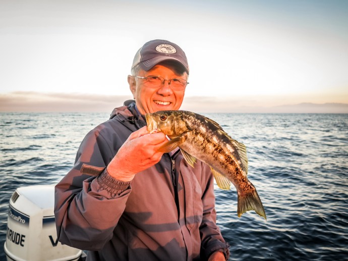 Peter Koga lands a nice calico with John Whitaker and Al Q. Photo by Al Q